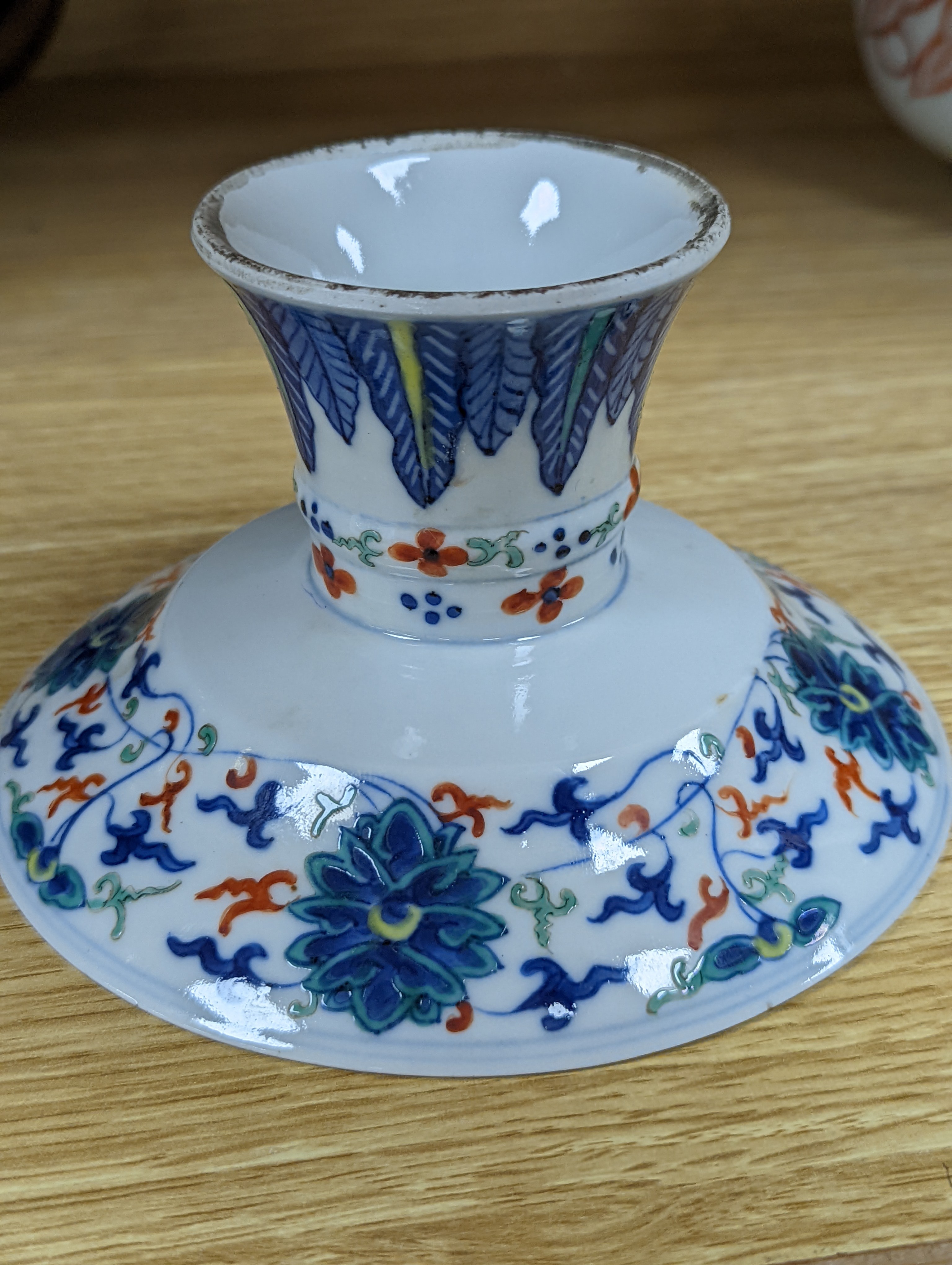 A Chinese blue and white water pipe vessel, a doucai stem dish and a Japanese Imari bowl, 19th century, (3)